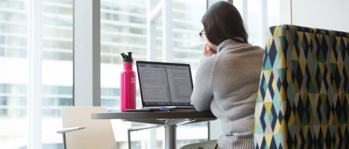 woman reading on laptop 