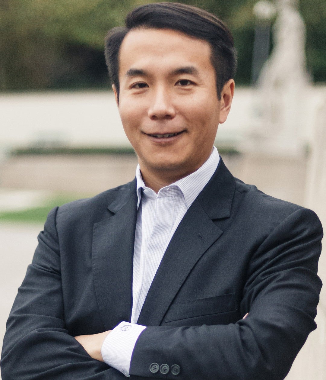 Zongqi Xia, associate professor of neurology and of biomedical informatics, School of Medicine, and of clinical and translational science at the University of Pittsburgh, stands for a headshot smiling with his arms folded.